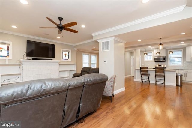 2306 Monticello Rd, Baltimore, MD 21216 - living area with recessed lighting, a ceiling fan, light wood-type flooring, healthy amount of natural light, and ornamental molding