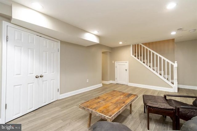2306 Monticello Rd, Baltimore, MD 21216 - living room featuring baseboards, light wood-style floors, stairs, and recessed lighting
