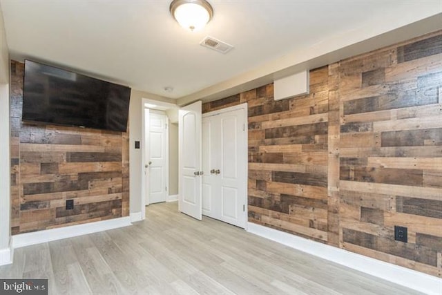 2306 Monticello Rd, Baltimore, MD 21216 - unfurnished bedroom with wood walls, wood finished floors, baseboards, and a closet