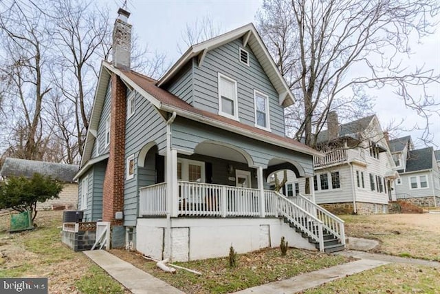 2306 Monticello Rd, Baltimore, MD 21216 - view of front of property with covered porch, a chimney, and stairway