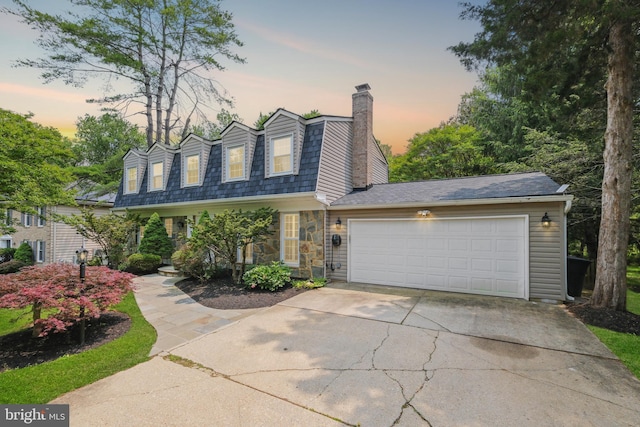 10104 Colebrook Ave, Potomac, MD 20854 - view of front of house featuring a chimney, driveway, a garage, and stone siding