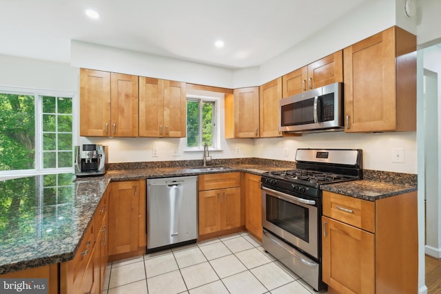 10104 Colebrook Ave, Potomac, MD 20854 - kitchen with appliances with stainless steel finishes, a sink, dark stone counters, recessed lighting, and brown cabinetry