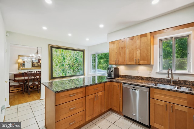 10104 Colebrook Ave, Potomac, MD 20854 - kitchen featuring stainless steel dishwasher, a sink, light tile patterned flooring, dark stone countertops, and brown cabinetry