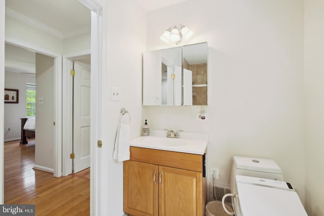 10104 Colebrook Ave, Potomac, MD 20854 - bathroom with wood finished floors, vanity, ornamental molding, toilet, and a shower
