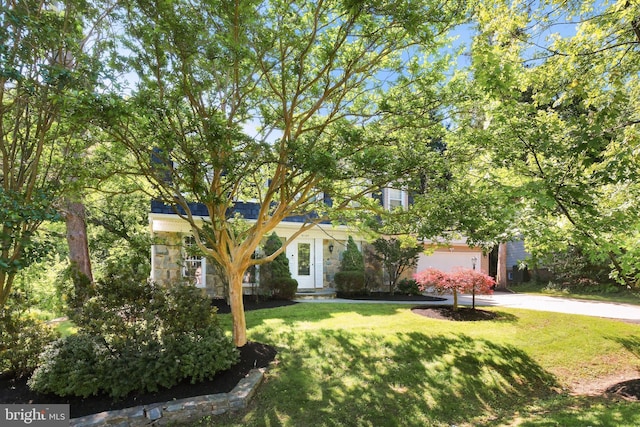 10104 Colebrook Ave, Potomac, MD 20854 - obstructed view of property featuring stone siding, a front yard, and concrete driveway
