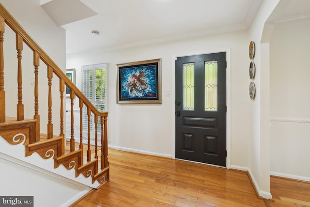 10104 Colebrook Ave, Potomac, MD 20854 - entrance foyer with light wood-style flooring, crown molding, stairway, baseboards, and arched walkways