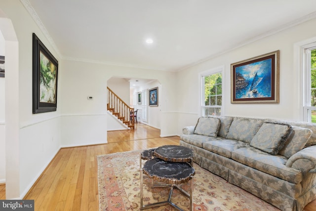 10104 Colebrook Ave, Potomac, MD 20854 - living area with arched walkways, healthy amount of natural light, ornamental molding, hardwood / wood-style floors, and stairway