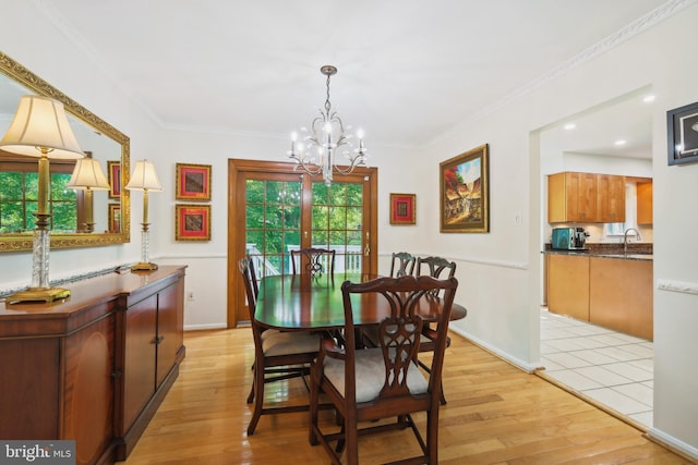 10104 Colebrook Ave, Potomac, MD 20854 - dining room with a chandelier, light wood-style floors, crown molding, and baseboards