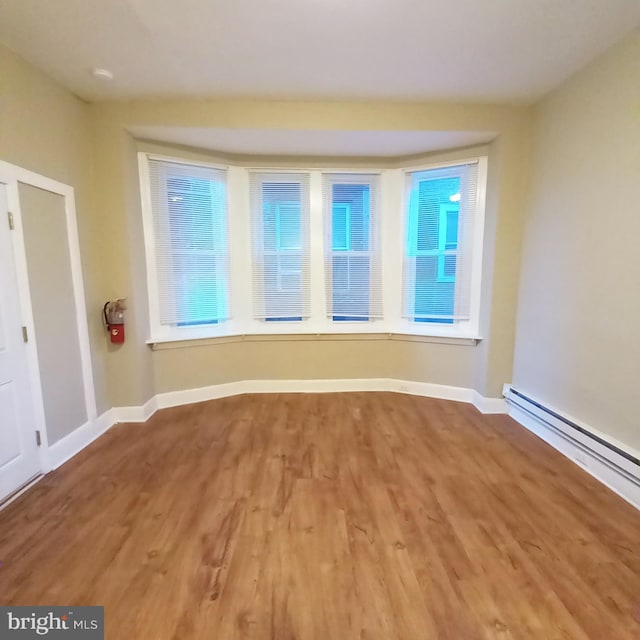 4623 N Broad St, Philadelphia, PA 19140 - unfurnished room featuring wood finished floors, baseboards, and a baseboard heating unit