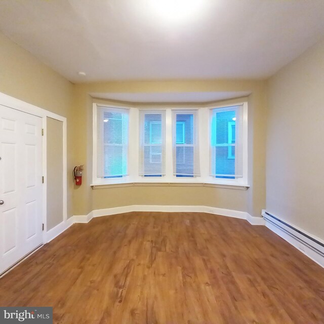 4623 N Broad St, Philadelphia, PA 19140 - spare room featuring wood finished floors, baseboard heating, and baseboards
