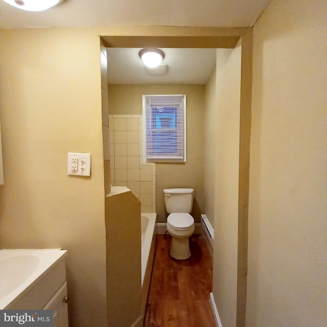 4623 N Broad St, Philadelphia, PA 19140 - full bathroom with a baseboard radiator, wood finished floors, toilet, vanity, and a bath