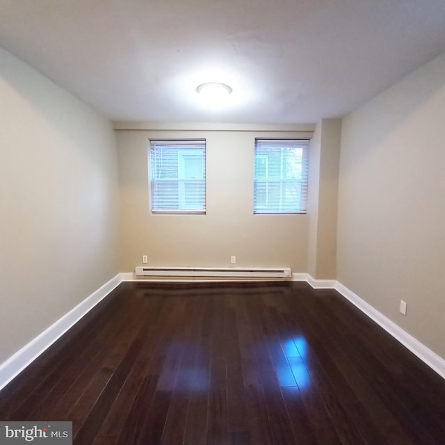 4623 N Broad St, Philadelphia, PA 19140 - unfurnished room with a baseboard heating unit, wood finished floors, and baseboards