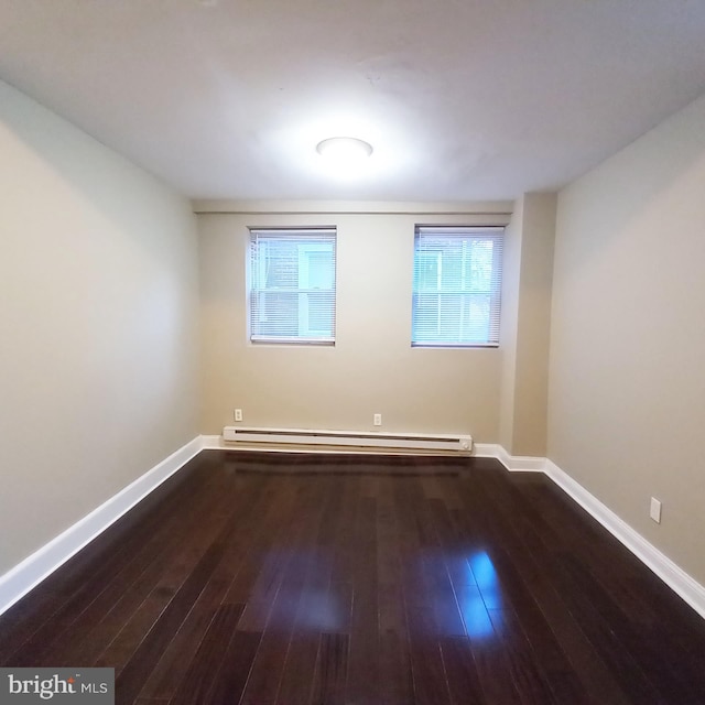 4623 N Broad St, Philadelphia, PA 19140 - unfurnished room featuring baseboard heating, wood-type flooring, and baseboards