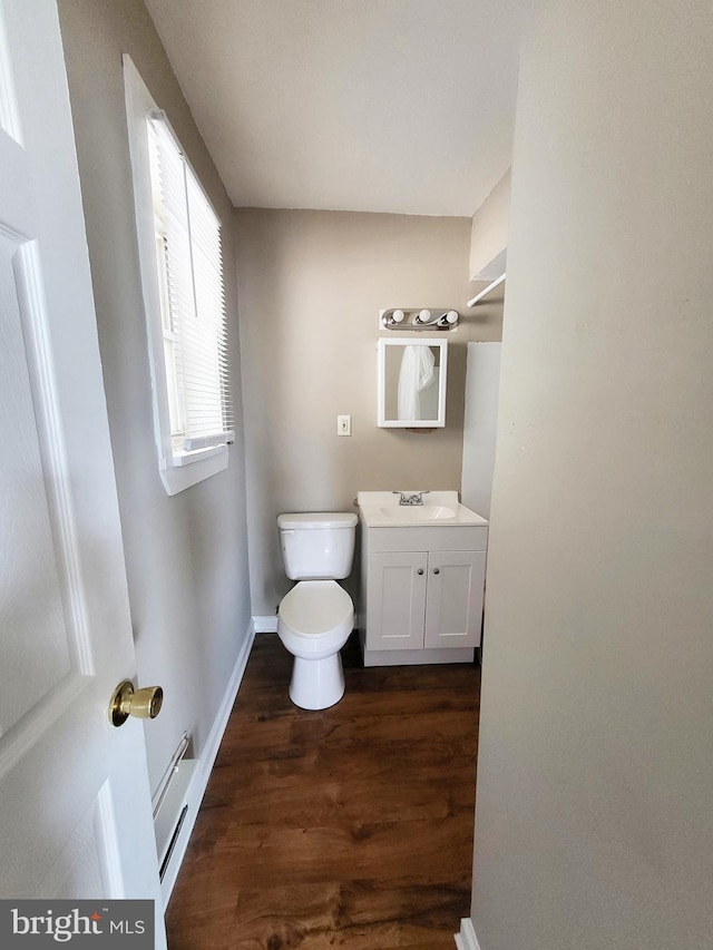 4623 N Broad St, Philadelphia, PA 19140 - half bath with wood finished floors, vanity, baseboards, toilet, and baseboard heating