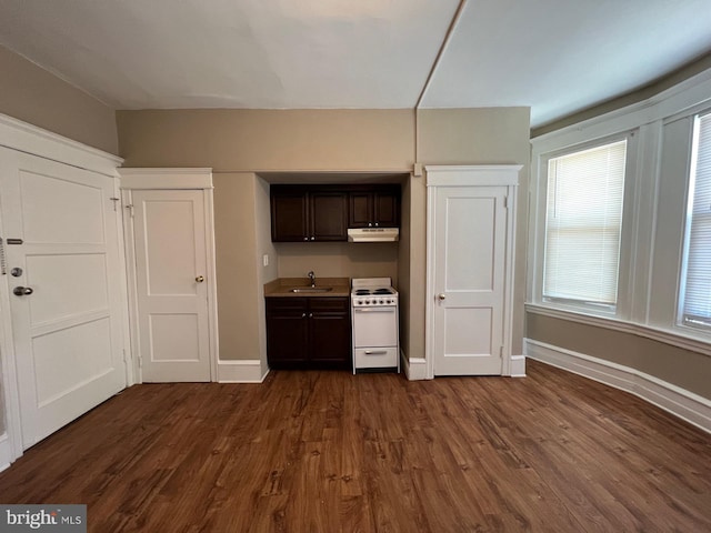 4623 N Broad St, Philadelphia, PA 19140 - kitchen with white electric range, under cabinet range hood, a sink, dark wood-style flooring, and dark brown cabinetry