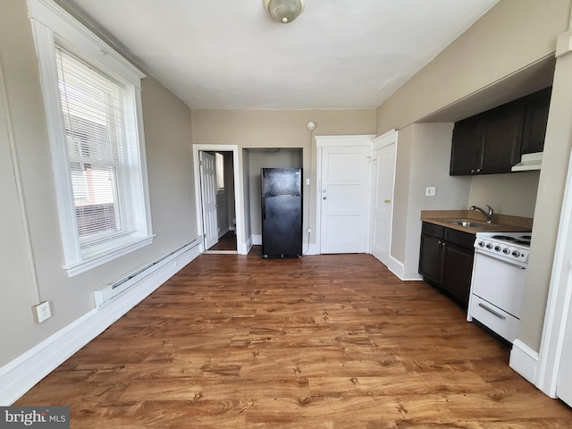 4623 N Broad St, Philadelphia, PA 19140 - kitchen featuring freestanding refrigerator, electric range, dark cabinets, a baseboard heating unit, and a sink