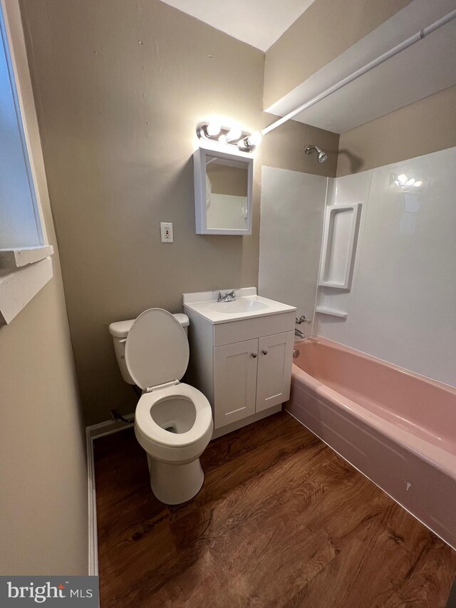 4623 N Broad St, Philadelphia, PA 19140 - bathroom featuring wood finished floors, toilet, washtub / shower combination, and vanity