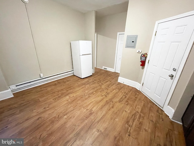 4623 N Broad St, Philadelphia, PA 19140 - spare room featuring a baseboard radiator, wood finished floors, lofted ceiling, electric panel, and baseboards
