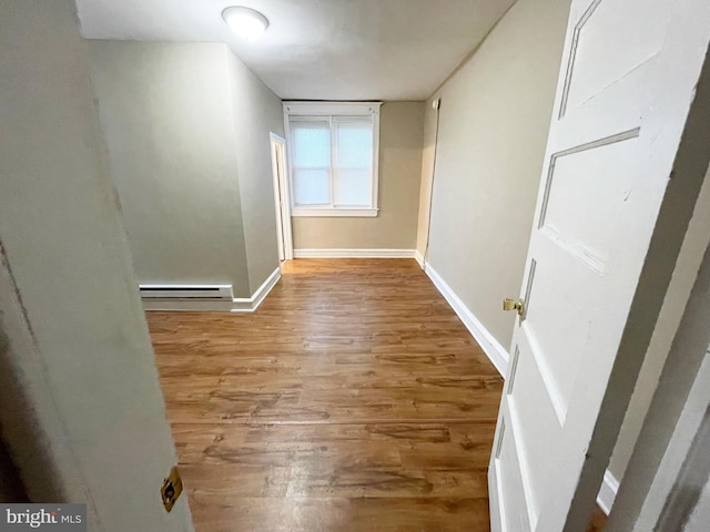 4623 N Broad St, Philadelphia, PA 19140 - empty room featuring wood finished floors, baseboards, and a baseboard heating unit