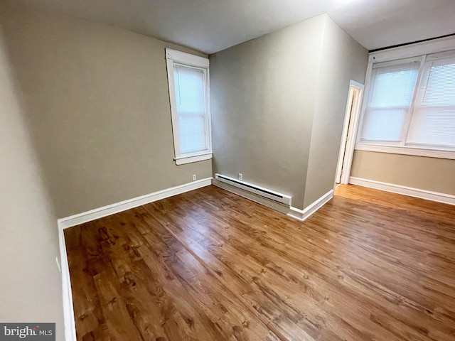 4623 N Broad St, Philadelphia, PA 19140 - spare room with baseboard heating, wood finished floors, baseboards, and plenty of natural light