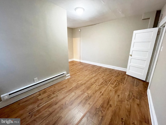 4623 N Broad St, Philadelphia, PA 19140 - empty room with baseboard heating, wood finished floors, and baseboards