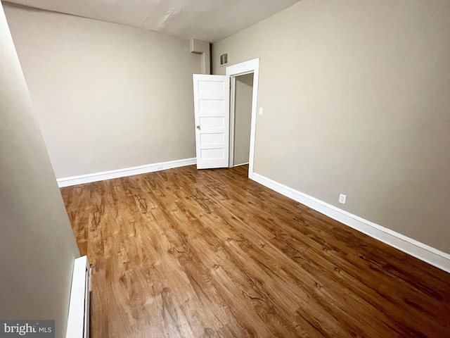 4623 N Broad St, Philadelphia, PA 19140 - spare room with wood finished floors, a baseboard heating unit, and baseboards