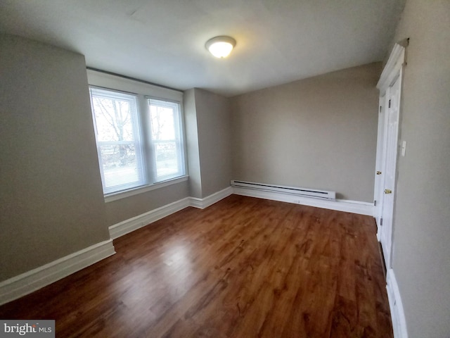4623 N Broad St, Philadelphia, PA 19140 - empty room featuring a baseboard radiator, wood finished floors, and baseboards
