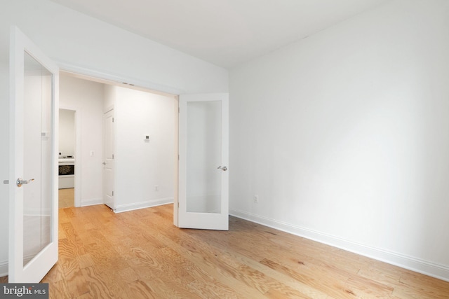 118 Milkweed Dr, Lake Frederick, VA 22630 - unfurnished bedroom featuring french doors, light wood-type flooring, and baseboards
