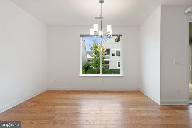 118 Milkweed Dr, Lake Frederick, VA 22630 - spare room with a chandelier, light wood-type flooring, and baseboards