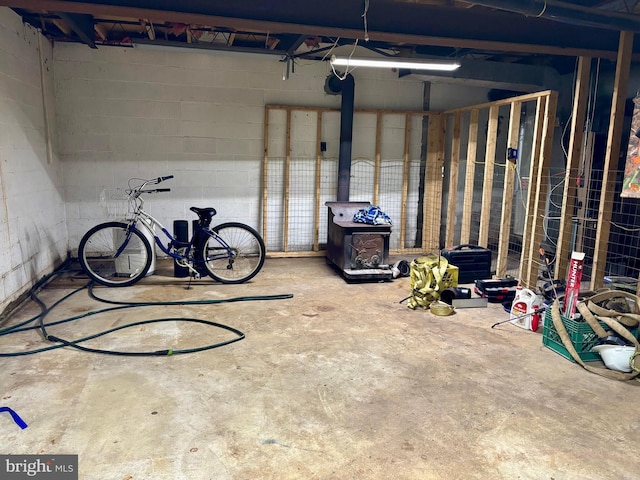 149 Smoketown Rd, Mertztown, PA 19539 - garage with concrete block wall and a wood stove