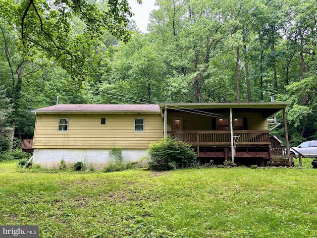 149 Smoketown Rd, Mertztown, PA 19539 - rear view of property featuring a lawn, a forest view, and a wooden deck