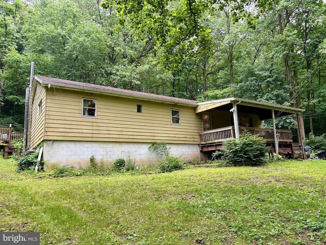 149 Smoketown Rd, Mertztown, PA 19539 - view of home's exterior with a lawn, a wooden deck, and a view of trees
