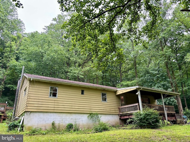 149 Smoketown Rd, Mertztown, PA 19539 - view of home's exterior featuring a view of trees and a wooden deck