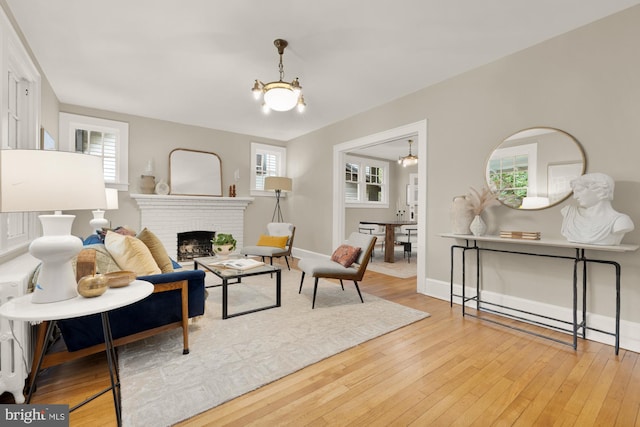 1505 Otis St NE, Washington, DC 20017 - living area with a chandelier, hardwood / wood-style flooring, a fireplace, and baseboards