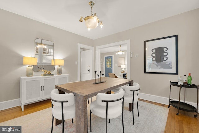 1505 Otis St NE, Washington, DC 20017 - dining room featuring light wood-style flooring, baseboards, and a chandelier