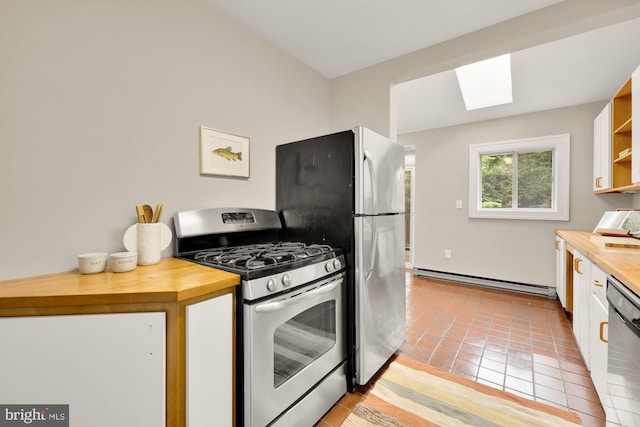1505 Otis St NE, Washington, DC 20017 - kitchen with appliances with stainless steel finishes, a baseboard heating unit, wooden counters, and a skylight