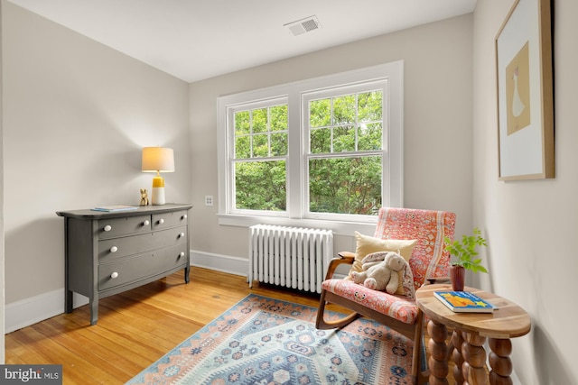 1505 Otis St NE, Washington, DC 20017 - living area featuring radiator heating unit, baseboards, and light wood-style flooring