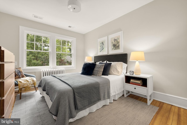 1505 Otis St NE, Washington, DC 20017 - bedroom featuring radiator heating unit, hardwood / wood-style floors, and baseboards