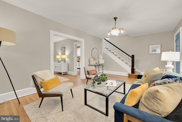 1505 Otis St NE, Washington, DC 20017 - living room featuring stairs, light wood-style floors, and baseboards