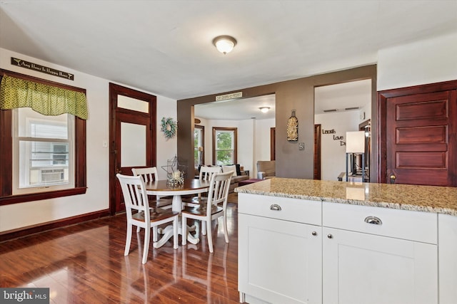 208 Franklin Ave, Souderton, PA 18964 - kitchen with dark wood-style flooring, light stone countertops, white cabinets, and baseboards