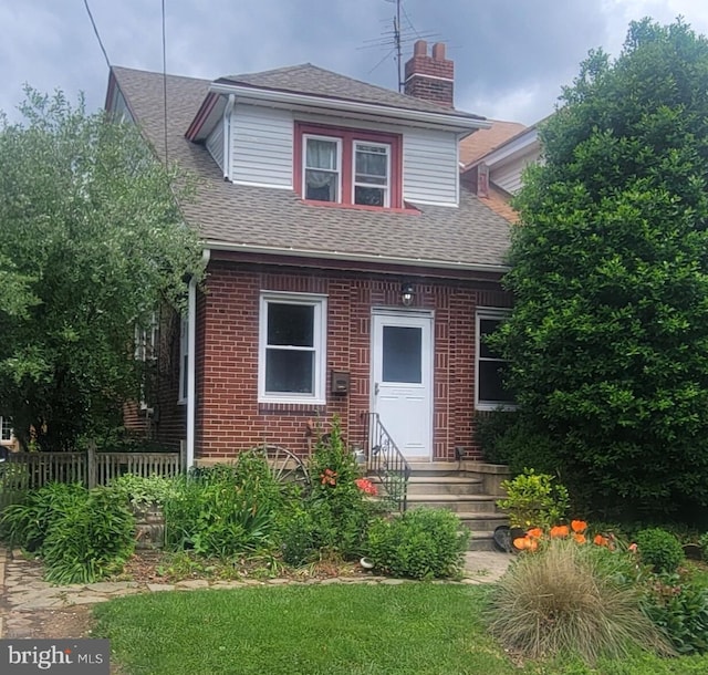 1857 Arthur St, Philadelphia, PA 19152 - view of front of house featuring brick siding, a shingled roof, and a chimney