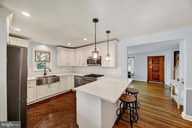 4220 E Joppa Rd, Nottingham, MD 21236 - kitchen with appliances with stainless steel finishes, a sink, a peninsula, backsplash, and recessed lighting