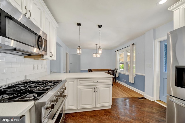 4220 E Joppa Rd, Nottingham, MD 21236 - kitchen with appliances with stainless steel finishes, light countertops, tasteful backsplash, dark wood-style floors, and white cabinetry