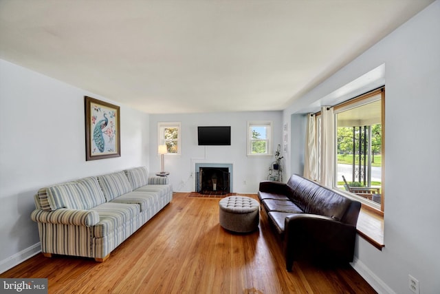 4220 E Joppa Rd, Nottingham, MD 21236 - living area with wood finished floors, a fireplace with flush hearth, and baseboards
