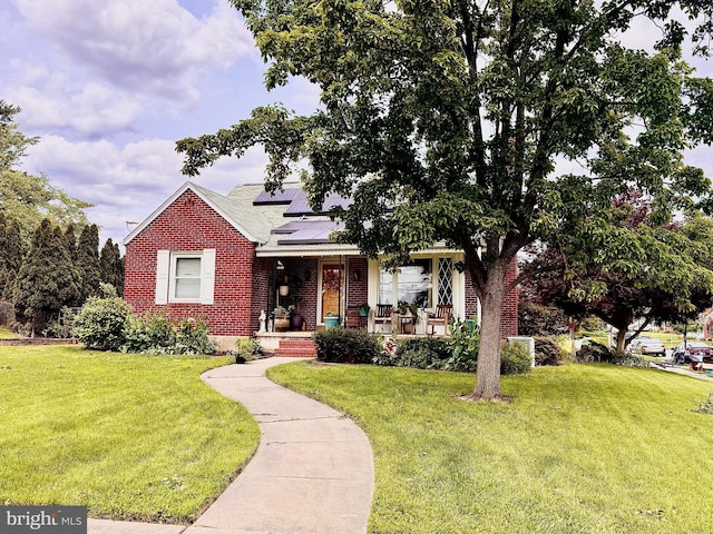 4220 E Joppa Rd, Nottingham, MD 21236 - view of front of house with covered porch, brick siding, roof mounted solar panels, and a front yard