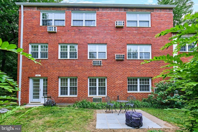 3501 Martha Custis Dr, Alexandria, VA 22302 - rear view of property featuring a patio area, brick siding, and a lawn