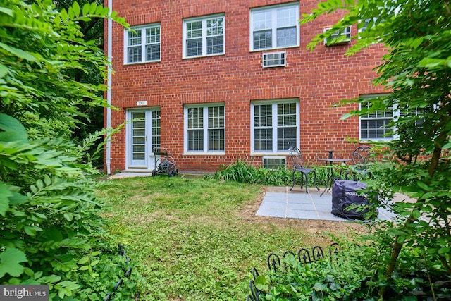 3501 Martha Custis Dr, Alexandria, VA 22302 - back of house featuring brick siding, a patio area, and a lawn