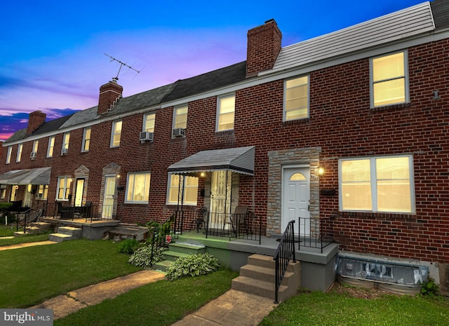 4937 Schaub Ave, Baltimore, MD 21206 - townhome / multi-family property with a chimney, brick siding, a front yard, and cooling unit