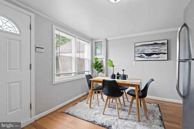 4937 Schaub Ave, Baltimore, MD 21206 - dining space featuring crown molding, wood finished floors, and baseboards