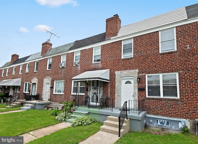 4937 Schaub Ave, Baltimore, MD 21206 - view of property with a chimney, a front lawn, and brick siding